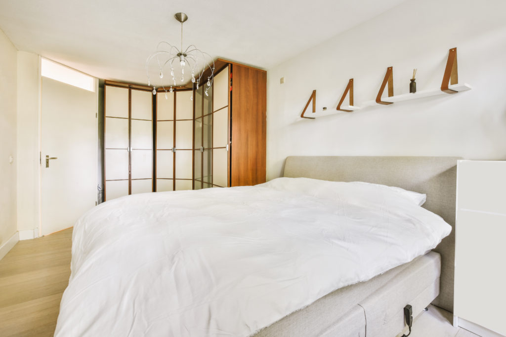 Light bedroom with wooden wardrobe