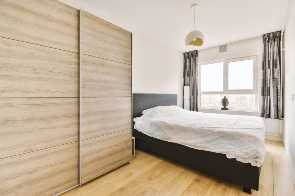 Stylish bedroom with bed and wardrobe